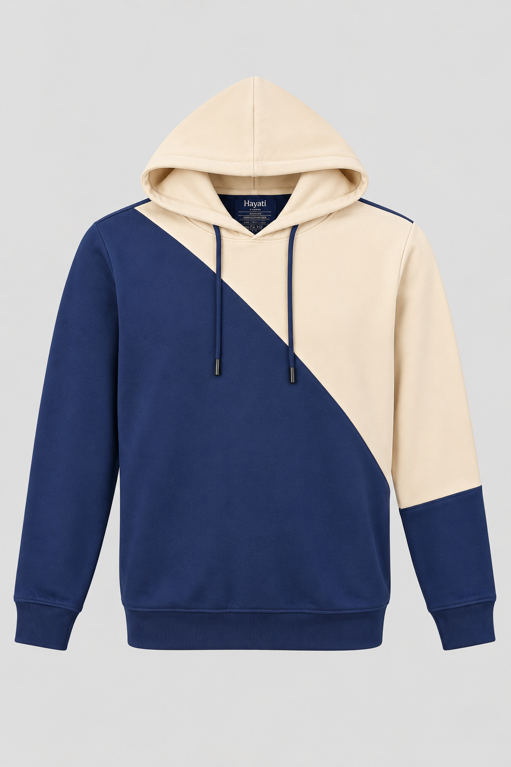 Ivory and navy colour-block pullover hoodie with a geometric diagonal design, drawstring hood, long sleeves, ribbed cuffs, and ribbed hem.